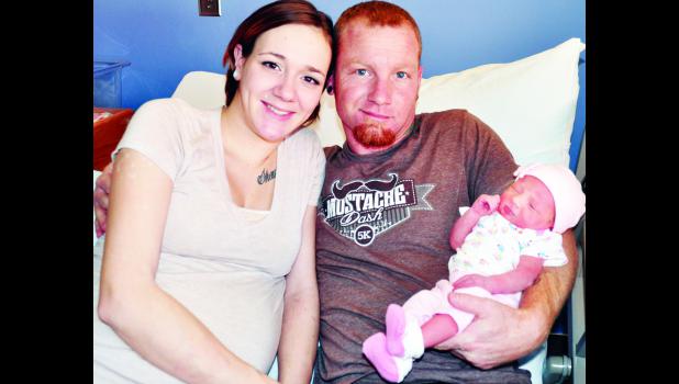 by Ali Holcomb New Holton residents Brandi Lopez (left) and Shaun Gates are the proud parents of Harley Raelynn Gates, the first baby born in 2015 at Holton Community Hospital.