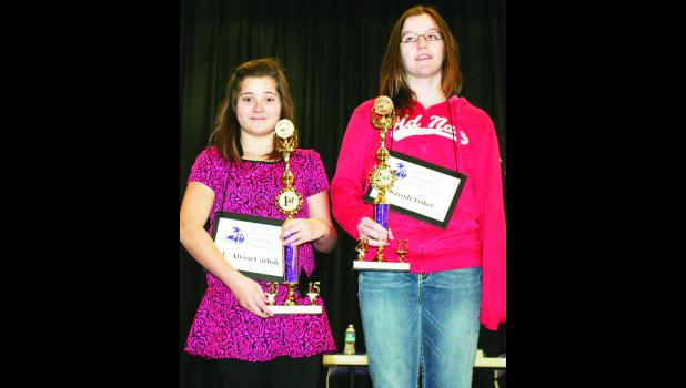 by Brian Sanders Alyssa Carlisle (left), a sixth-grade student at Royal Valley Middle School, won the Jackson County Spelling Bee on Saturday, while Kassidy Fisher (right), a sixth-grade student at Holton Middle School, took second place in the bee. Both will go to the regional spelling bee on Saturday, March 7 at Seaman High School in Topeka.