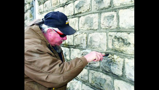 by Brian Sanders Holton Parks and Recreation employee Jerry Tudor took a walk around the outside of the limestone-walled bath house at the Holton Municipal Swimming Pool on Tuesday, looking at cracks in the limestone that are in need of repair. Replacing the limestone on the historic building would have a "phenomenal" cost, Tudor said. The pool's condition was mentioned by Parks and Recreation Director Mike Reichle at Monday's Holton City Commission meeting.