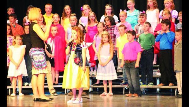 Third-grade students at Central Elementary School performed “The Granny Awards” at their spring concert last week, which featured characters from a variety of fairy tales. In the photo above, Snow White (center), played by Mariah Woltje, sang a song under the direction of Sheri Bartel (left), music instructor.