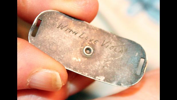 This inscription on the back of a World War II-era bracelet, discovered in the desert near Phoenix, Ariz., touched off a search for the woman who had it inscribed on the bracelet — Viola Row, nee Richter, a 1944 graduate of Holton High School. Row had bought the bracelet for her boyfriend, 1940 HHS graduate George Zellers, who had the bracelet with him when he was killed in an air training accident in February of 1944. (Photo by Brian Sanders)