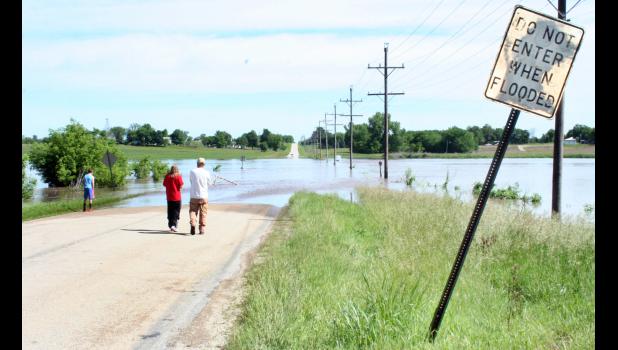 Heavy rains in recent days caused Elk Creek to overrun its banks on Friday morning, spreading water over Old U.S. Highway 75 north of Holton. It was the first time in several years that Old 75 had been closed by floods, although by afternoon Friday, the waters had receded. Many Jackson County roads were closed by flooding on Friday, it was reported. (Photo by Brian Sanders)