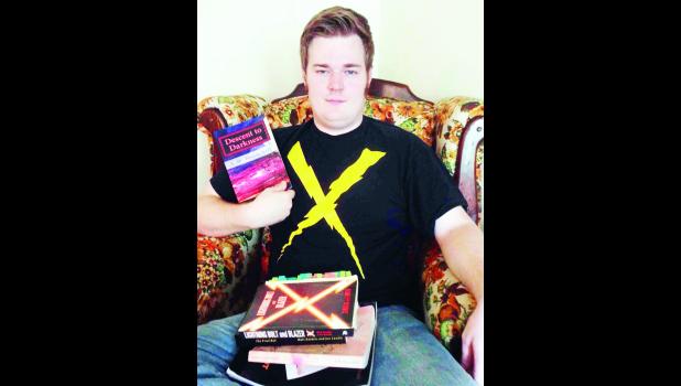 Submitted photo Hoyt native Alex Hounchell is shown above with his published novels. Hounchell recently published his fourth novel, "Running Out Of Time." He is a student at Washburn University.