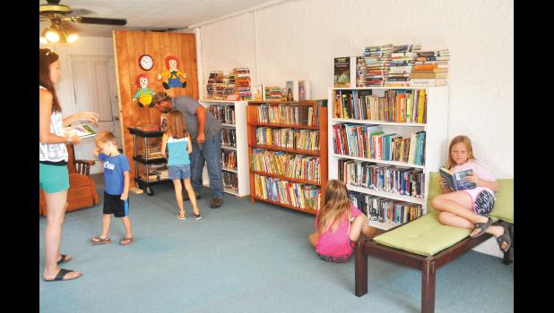People of all ages paid a visit to the new volunteer-led Denison public library on Friday, when a grand opening ceremony was held. (Photo by Ali Holcomb)