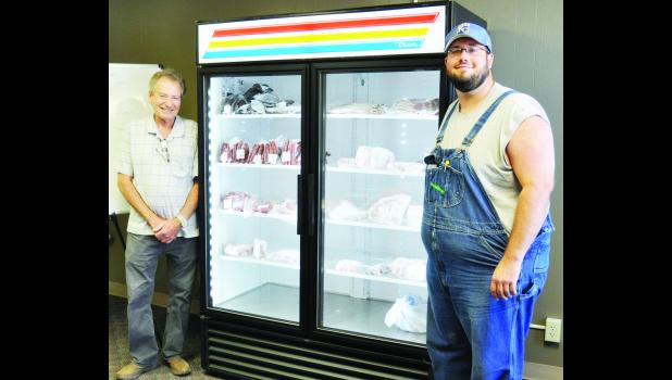 by Ali Holcomb Heartland Meat Market opened recently in downtown Holton, offering a wide selection of meats. Shown in the above photo are employee Billy McCauley (left) and owner David Tinney (right). Tinney owns the business with Matt McCauley.