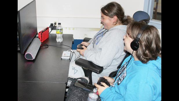 HHS students Nora Nordyke (left) and Carleigh Culver, members of the school's e-sports team, enjoy a recent practice. (Photo by Brian Sanders)