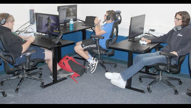HHS students (from left) John Frederick Myers, Bryson York and Kayde Taylor, members of the school's e-sports team, enjoy a recent practice. (Photo by Brian Sanders)