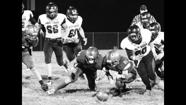 Kelly Breckunitch HHS linebackers Indie Allen (shown above, lower left) and Mason Barta (lower right) dive forward to recover a fumble early in Friday's district contest against Jeff West.
