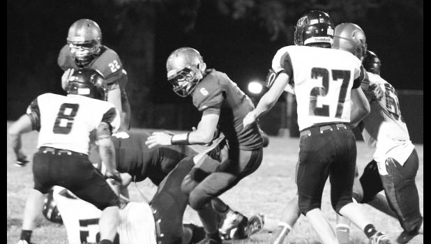 Kelly Breckunitch Wildcat running back Lucas Lovvorn (shown above, middle) tries to spin away from some Tiger defenders for a few extra yards. Lovvorn struck the opening blow with a 44-yard score that started Holton on its way to a 38-6 victory.