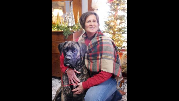 The home of Trisha McAlexander (shown with Kamo the dog), located west of Holton, will be featured on this year’s Christmas Homes Tour. (Photo by Ali Holcomb)