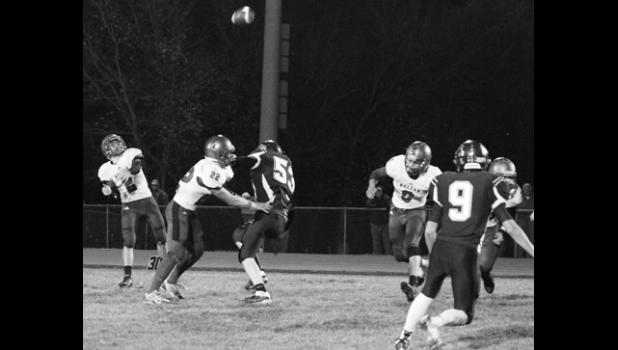 Kelly Breckunitch Wildcat quarterback Justin Rieschick (shown above, far left) lets a pass fly during the first half of the district battle against Royal Valley. HHS stuck to the ground through most of the night, though, in a big win over RV.