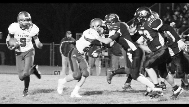 Kelly Breckunitch Holton running back Will Wright (shown above, far left) sprints to the outside, following the block of teammate Justin Pool (middle left) while trying to evade RV defender Noah Howerton (right) during Friday's district match-up