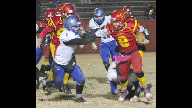 By Kelly Breckunitch Holton's Trey Tanking (shown above, left) lunges after a Columbus ball carrier to bring him down early in last Friday's game.