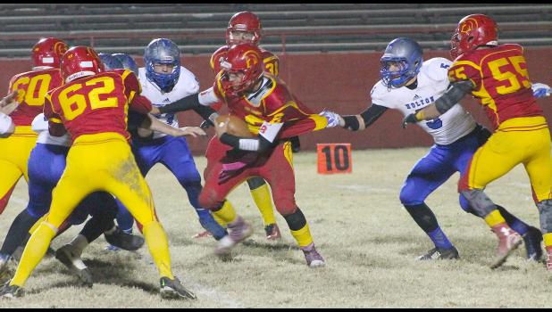 By Kelly Breckunitch Wildcat Kaden Brandt (shown above, right) grabs a hold of Titan QB Nate Bole to slow him up and allow his teammates to converge for a tackle in the sectional match-up against Columbus.