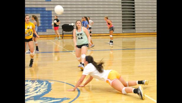 By Kelly Breckunitch Holton's Megan Rhule (shown above, at left) and Shari Riley (middle) look on as teammate Hayley Thompson (diving, at right) lays out to save a ball during a recent practice. All three played key roles in the team's two wins to open the season on Tuesday.