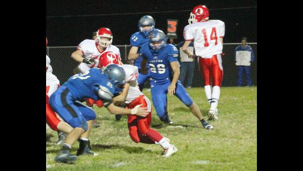 By Kelly Breckunitch Holton linebacker Mason Barta (shown above, left) penetrates the line of scrimmage to make a stop in regional action last Friday.