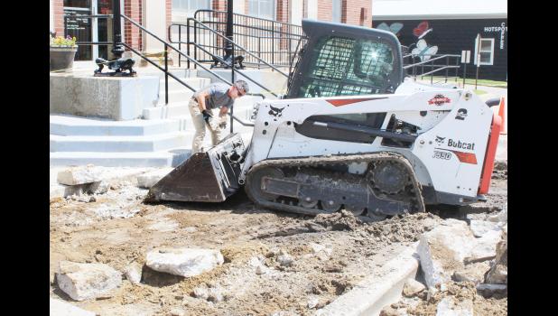 Sidewalk repair in front of the U.S. Post Office in Holton continued on July 7 with Wayne West (shown above) of HydraCorp of Lee’s Summit, Mo., removing chunks of old sidewalk concrete that had settled in front of the post office steps. West said he is hoping to have the repair project finished by the end of next week, weather permitting. (Photo by Brian Sanders)