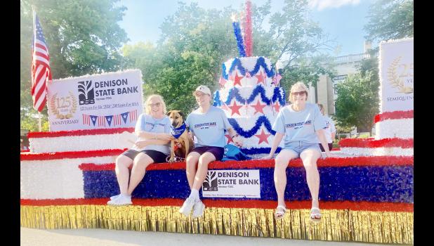The Denison State Bank float for the Jackson County Fair Parade here on Wednesday, July 15 featured a 125th year bank anniversary birthday cake and sign and an overall grand patriotic theme also celebrating our nation’s 250th birthday year. Shown in the photo on the float are, left to right, Paula Taylor, CEO, and her son Carson and his dog Blaire and JoAnne Myers, custom service rep/teller at DSB. (Photo by David Powls)