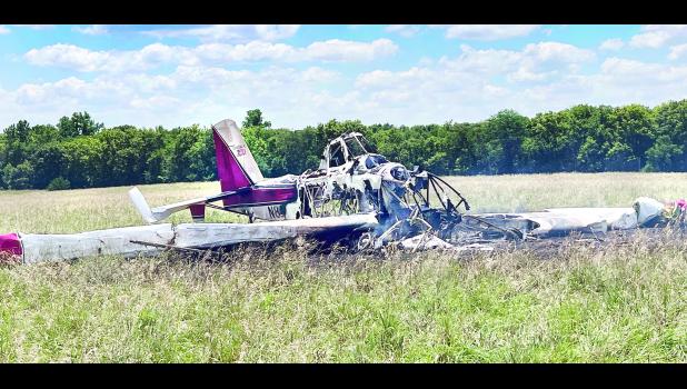 A crop-dusting airplane is shown above burned in a field northeast of Whiting after crashing here Monday afternoon. The pilot, David Brocklehurst, 49, of Vernon, Texas, escaped with no life-threatening injuries after the plane reportedly struck a communication pole that marked a natural gas line before crashing and catching fire.  