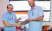Holton High School e-sports coach Dillon Kathrens (at left) recently received a $5,044.72 donation from Giant Communications general manager Austin Taylor (at right) for the e-sports program at HHS. (Photo by Brian Sanders)