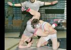 Holton's Justin Rieschick (right) flipped Jake Patterson of Shawnee Heights near the end of Rieschick's come-from-behind victory in the 145-lb. division championship match at Saturday's Gerald Sadowski Invitational tournament in Holton. (Photo by Brian Sanders)