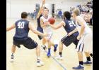 Holton's Bryson Patch (center) stepped through a trio of Sabetha Blue Jay defenders to go for a score, with teammate Aaron Bain (at right) at the ready for a pass. Patch contributed 25 points to the Wildcats' 47-38 victory on Friday. (Photo by Brian Sanders)