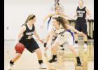 Holton's Sarah Lierz (center right) attempts to block a Sabetha team member while Mackenzie Moore (center rear) holds off another Blue Jay in Friday's night's game. (Photo by Brian Sanders)