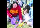 Six-year-old Charlie Robertson (at right) of Holton checked out her haul of Easter eggs, with some help from her mother, Regina Robertson, during the recent hunt hosted by the Jackson County 4-H Ambassadors at the Northeast Kansas Heritage Complex.