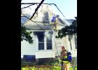 Firefighters from fire departments in southern Jackson County are shown battling a fire Tuesday morning at 104 Highland Ave. in Hoyt. It was reported that all the occupants of the house were able to exit the house, including one person who jumped to the ground from an upstairs window. 
