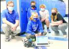 Dustin McBride, Holton Middle School technology teacher, is shown at left with a group of seventh-grade students as they work to code a robot to travel through the school. Coding, robotics and 3D printing are some of the options available to HMS students in tech courses offered by McBride. Seventh-graders shown with McBride include Kolbie Noel (front) and (back, from left) Jacob Warner, Andrew Keithley and Kylie Carlsen. (Photo by Ali Holcomb)