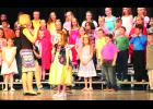 Third-grade students at Central Elementary School performed “The Granny Awards” at their spring concert last week, which featured characters from a variety of fairy tales. In the photo above, Snow White (center), played by Mariah Woltje, sang a song under the direction of Sheri Bartel (left), music instructor.