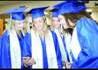 Holton High School graduating seniors (from left to right) Macey Gross, Grace Gallagher, Sadie Walker and Taylor Moore gathered around a cell phone to check the quality of a group photo taken just before they and their classmates went through commencement ceremonies on Saturday in the HHS gym.