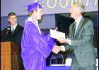 Royal Valley Superintendent John Rundle (right) is shown handing a diploma to graduating senior Nick Ehrhart (center) during Royal Valley High School’s graduation on Sunday. Assistant High School Principal Travis Van Vleck is shown at left. This was Rundle’s last graduation at Royal Valley as he is retiring at the end of the school year. 
