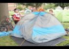 Gerry Ibay (at left) of Edmond, Okla., helped his sister-in-law, Linda Bean of Girard (at right), put up a tent on the Holton High School front lawn after they arrived in Holton on Friday with a group of more than 700 bicyclists taking part in the 50th-annual Biking Across Kansas trip across the state. Friday’s BAK stop in Holton marked the fifth time in the event’s history that the city served as the cross-state trip’s final overnight stop. (Photo by Brian Sanders)