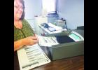 Jackson County Clerk Kathy Mick programmed one of the county’s 11 vote-scanning machines. After this year’s elections, Mick said, the county will be purchasing new vote-scanning machines. Since the vote-scanning machines are not used every year, she said, it is very important to have the written programming directions in hand. Before each election, the county clerk’s office must certify that the machines have been programmed correctly and are in good-working condition. (Photo by David Powls)