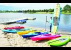 John Kennedy, Banner Creek Reservoir director, is shown above with several paddleboards and kayaks now available to rent at the reservoir. The equipment comes in both adult and youth sizes. In addition, two paddleboats (shown in the background) are available to rent. 
