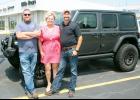 David Ellis of Ellis Boys Chrysler Dodge Jeep Ram in Holton is shown at right with wife Elise (center) and son Adam. (Photo by Brian Sanders)