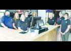Dennis Edmonds (shown above at far left) recently opened the Shine Runners liquor store at 204 Arizona Ave. Store employees, shown from left in the photo above, include Edmonds, Sarah Edmonds, Mary Teeter, Madeline Montgomery, Barbara Mattox, Otha Robinson, Jessie Robinson and Megan Montgomery.           