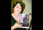 Lisa Deghand is shown above holding a picture of her late husband, Sergeant First Class Bernard Lee Deghand, who was killed in Afghanistan.             
