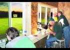 The new press box at the Jackson Heights High School football field is still a work in progress, but enough work has been completed to enable the school to use it. Announcer Kelly Bagley (third from right) called a recent Cobras football game with Lyle Alley (second from right) and Mark Fenton (at right) looking on, while Robin Sides (at far left) ran the scoreboard. 