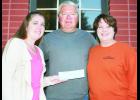 A total of 13 booths featuring 14 chili recipes and one soup were offered during the Chili Cook-Off held here on Saturday. The event raised $1,000 for the Holton Fire Department. Presenting the check to Holton Fire Chief Kevin Ingels (center) are Errin Edwards (left) and Shannon Schmille (right) of The Holton Recorder. 