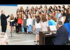 Holton Middle School vocal music instructor Randall Bond (at left in above photo) led the sixth grade choirs at HMS through “The Bare Necessities” from Disney’s “Jungle Book” during the HMS fall concert on Tuesday in the HMS gym. Renovation work was continuing in the HHS auditorium, where the concert normally would have been held, Bond said.	 (Photo by Brian Sanders)
