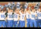 Holton High School football players (from left) Carson Meerpohl, Tyler Price, Parker Zeller, Miles McClintock-Strozier, Mason Strader, Spencer Baum (with trophy) and Brandon Lehnherr celebrated after the Wildcats won their Class 4A-Division II regional playoff game against Baldwin by a score of 20-14. The Wildcats (6-4) will host Frontenac (10-0) at 7 p.m. this Friday in the sectional round of football playoffs. (Photo by Michael Powls)