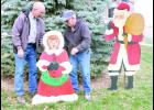 Several volunteers spent yesterday afternoon preparing the south side of the Jackson County Courthouse courtyard for the Christmas season. In the photo above, Jerry Mencl (at left), a Courthouse custodian, and Gary Shupe (at right) are shown installing several of the historic Christmas displays, including a caroler and Santa Claus, in the courtyard. 