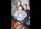 Nine-year-old Clay Goodman (center) recently took a toy display to the National Farm Toy Show in Dyersville, Iowa, and took third place in the nation for his age group. Clay is shown with his parents, Jeff (left) and Ashley Goodman, along with some of the toys Clay works with in his displays. (Photo by Brian Sanders)