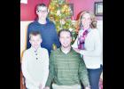 The Meerpohl family, including (clockwise from upper left) Carson, Nicole, Brian and Carter (not pictured: Ashtin Meerpohl), pose with one of a handful of Christmas trees that may be found in their home during the 2015 Christmas Homes Tour. (Photo by Ali Holcomb)