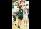 Jackson Heights sophomore Trinity McMahon (20, right) puts up a shot against a pair of Immaculata defenders during Friday's Cobras-Raiders match-up in the JHHS gym. McMahon contributed three points to the Cobras' 52-29 win.
