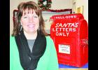 Jennifer Ingels of Holton, standing at the ready to help deliver those last-minute letters to Santa Claus, has been named the new postmaster at the Holton Post Office. She is a native of Denison and has worked for the post office since 1999. (Photo by Ali Holcomb)