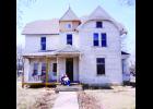 Marshall Barrington (at left) and Theresa SparrowSmith are shown above sitting on the front porch of their 148-year-old Victorian home that they call “Isabelle,” at 425 Wisconsin Ave. in Holton as restoration work continues. The couple is rebuilding the historic property from the ground up with plans to preserve its original character. 										 