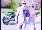 In the photo above, Jackson Heights students Mason Hare (at left) and Jennifer Mellies (at right) arrived to the school’s prom last Saturday evening on dirt bikes and walked the red carpet as family and friends looked on. 		